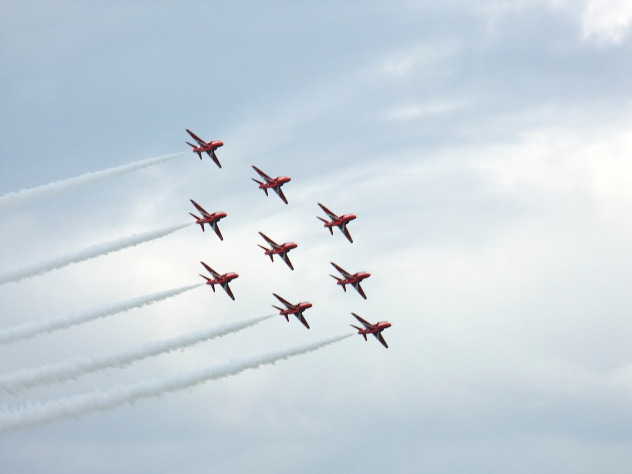 RAF Red Arrows diamond formation with white smoke trails