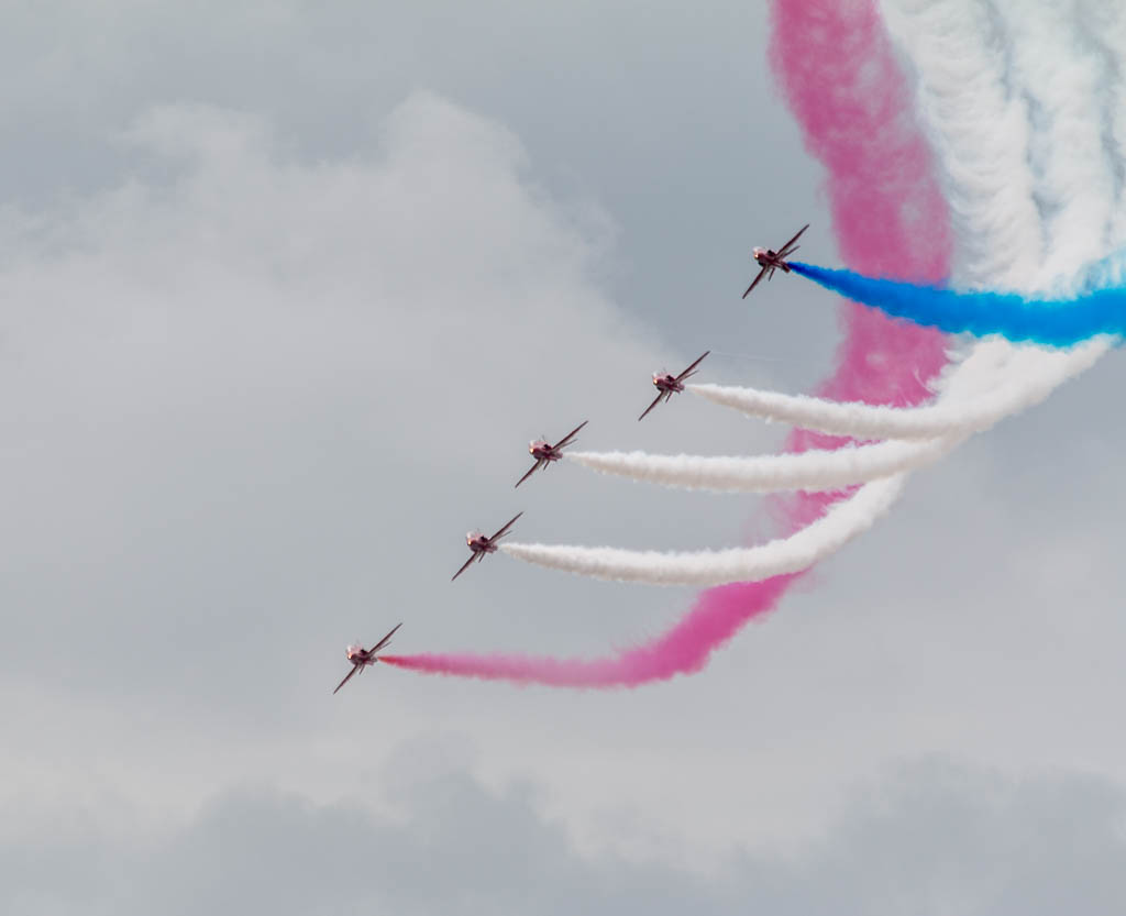 Military aircraft flying above Eastbourne seafront crowds
