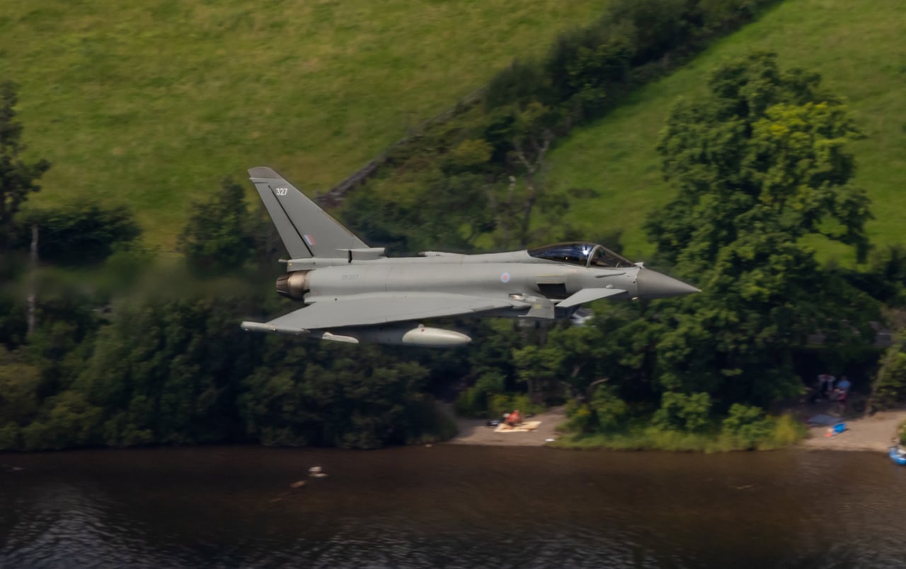 RAF Typhoon low over water in a UK valley