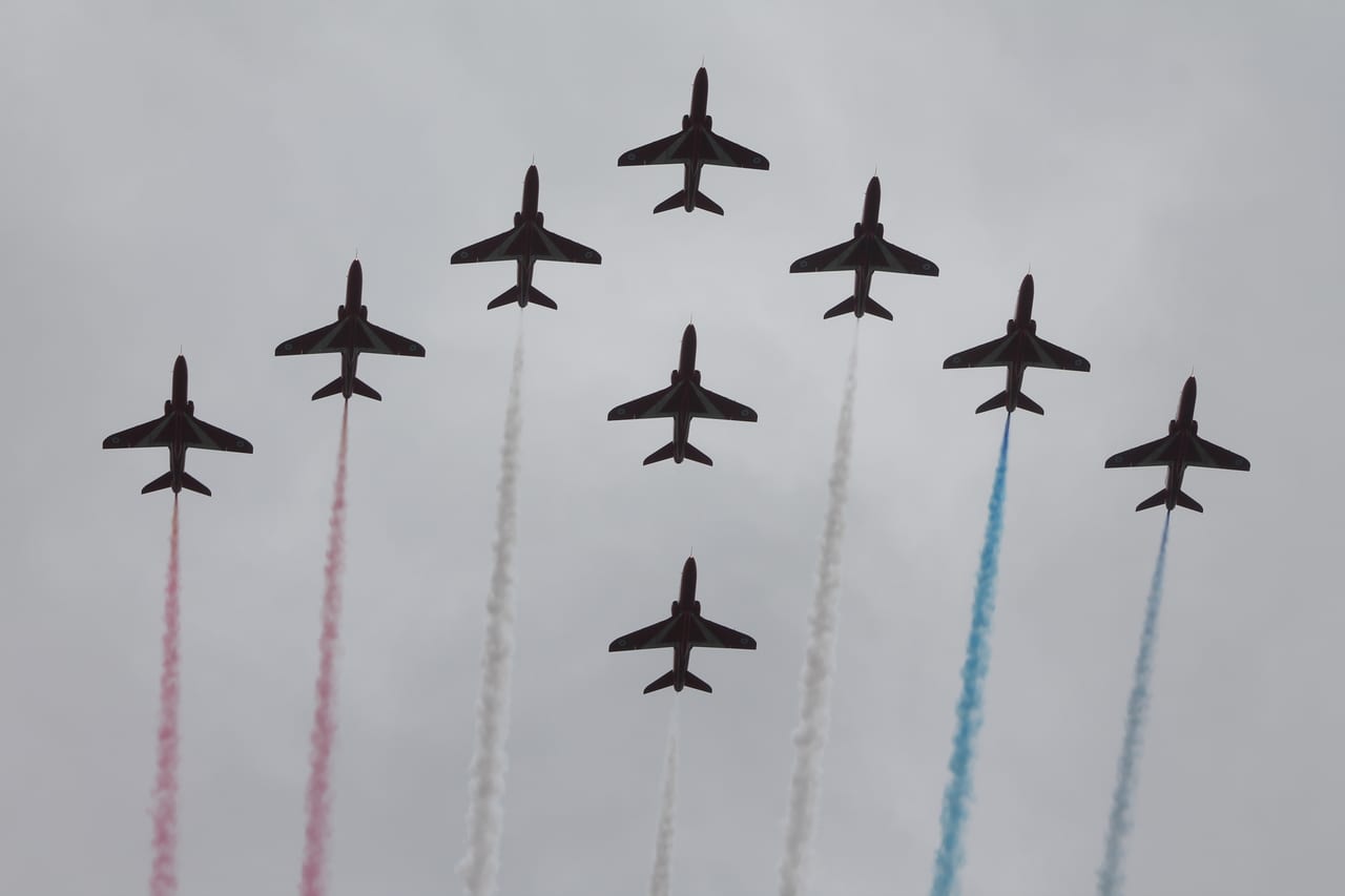 RAF Red Arrows in diamond formation with red white and blue smoke