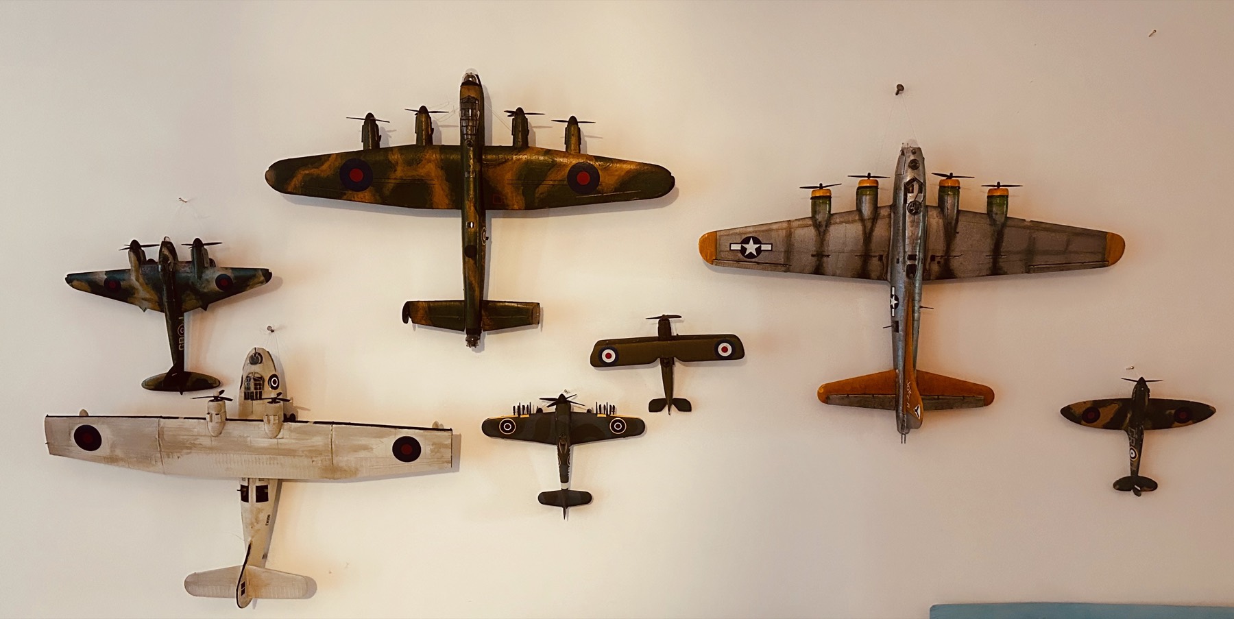 A wall of hand-built model aircraft hung in formation — bombers, flying boats and fighters seen from above