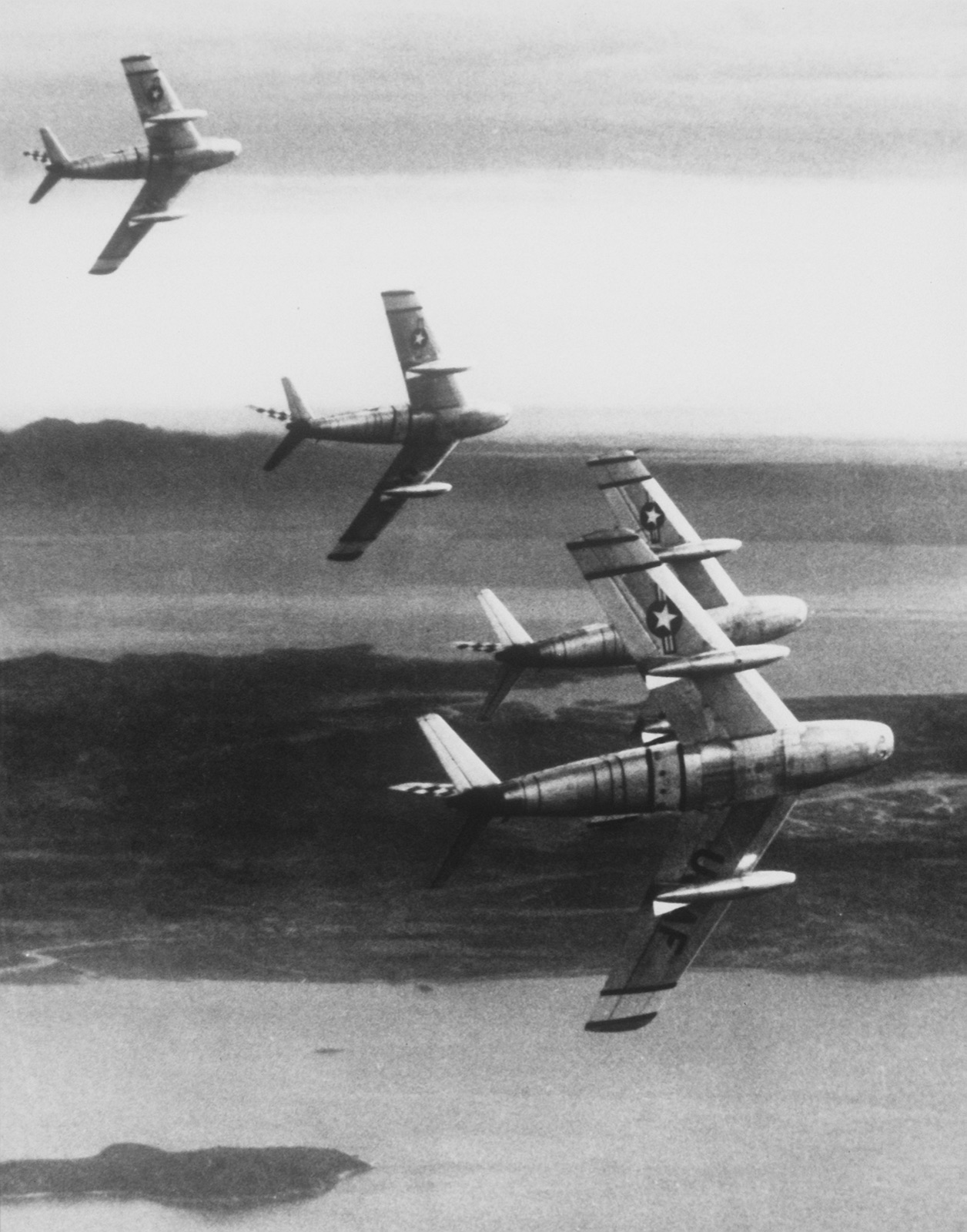 Four F-86 Sabres of the 51st Fighter-Interceptor Wing breaking left in formation over Korea.