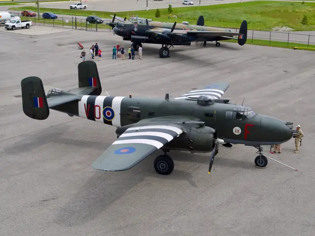 Olive-green B-25 Mitchell bomber with black-and-white invasion stripes and RAF roundels parked on a concrete apron