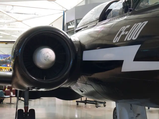 Close view of a black Avro Canada CF-100 jet fighter's engine intake and white lightning-bolt flash on the fuselage