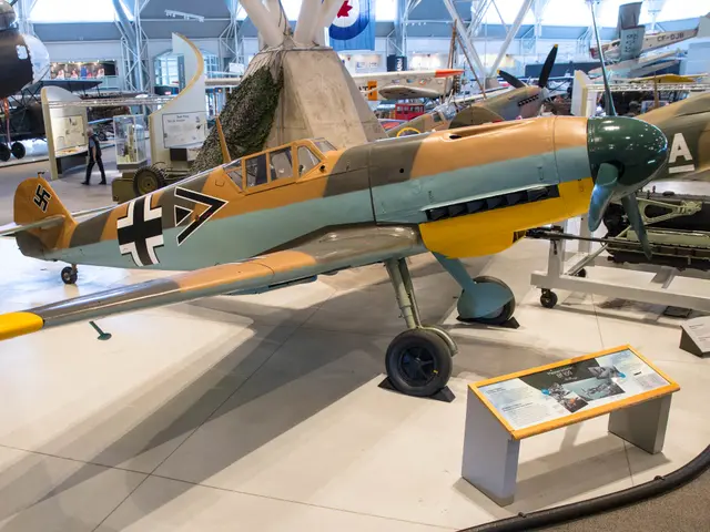 Messerschmitt Bf 109F in sand and green camouflage with a yellow nose, on display beside an information panel