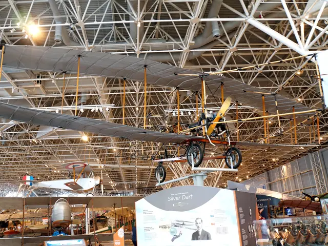 Pioneer pusher biplane with long silver wings, displayed raised above the Early Aviation gallery