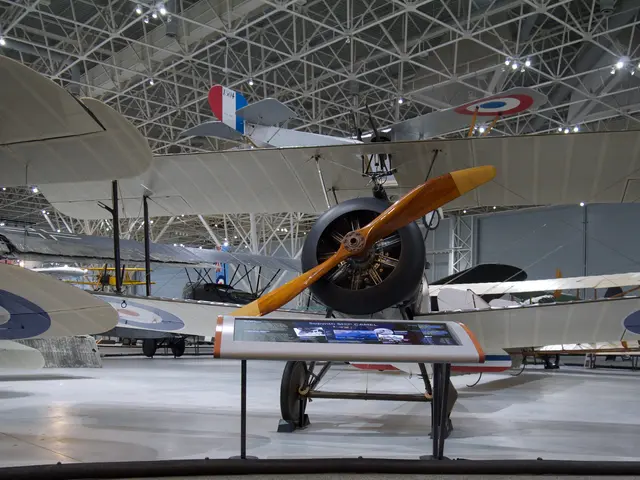 Silver-doped Sopwith Camel biplane with RAF roundels and a wooden propeller, seen head-on