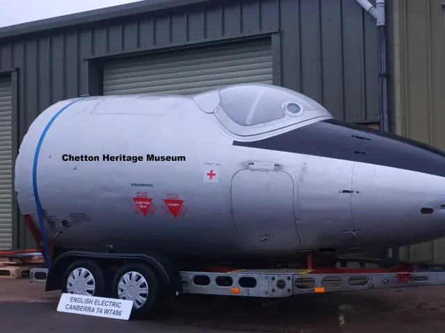 Silver Canberra nose section on a trailer, lettered Chetton Heritage Museum, in front of a green steel building