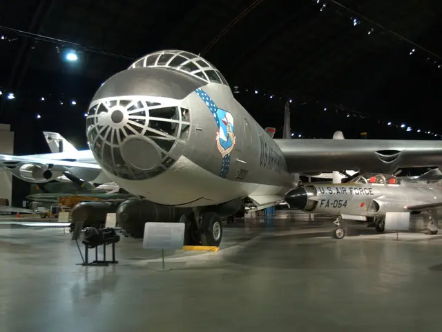 The huge six-engined B-36J bomber with a small F-94C jet fighter parked beneath its wing in the Cold War Gallery