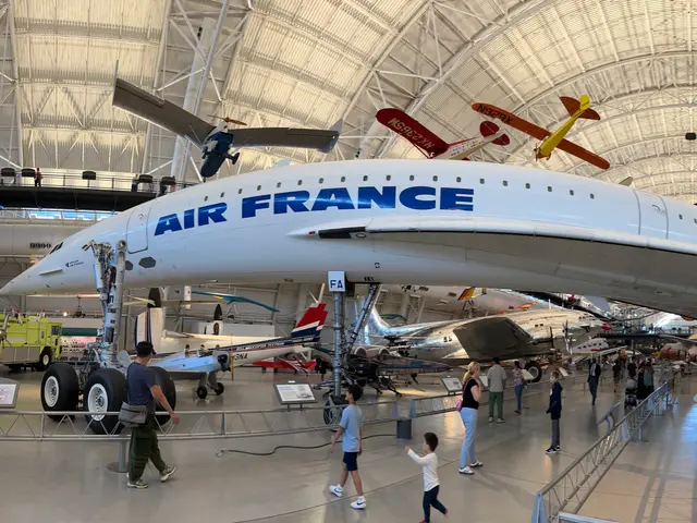 Side view of the white Air France Concorde F-BVFA on the hangar floor with visitors walking past