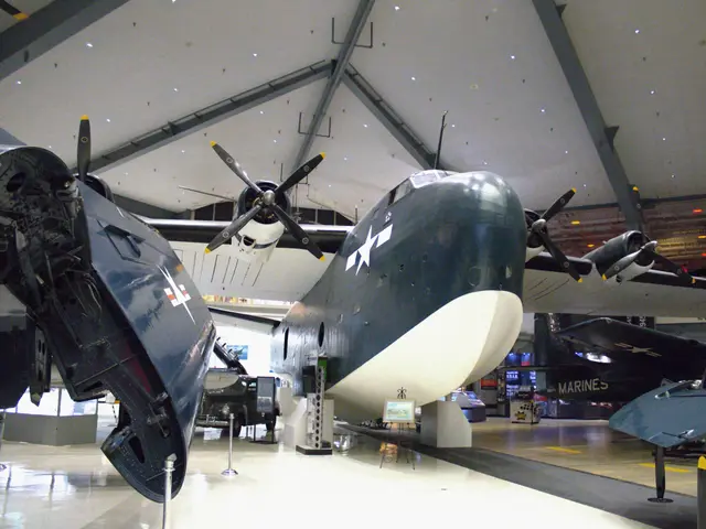 Dark blue four-engined flying boat nose seen head-on in a museum hall