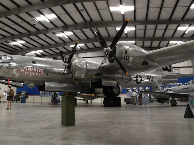 Polished silver B-29 Superfortress bomber inside a hangar