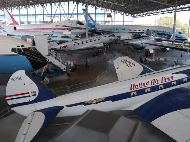 Open-sided steel pavilion sheltering a United Boeing 247, a TWA DC-2, the 747 prototype and other aircraft