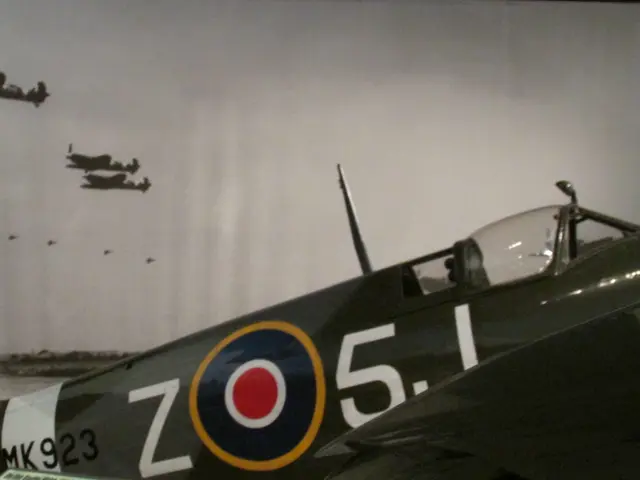 Rear fuselage of a camouflaged Spitfire showing RAF roundel and serial MK923