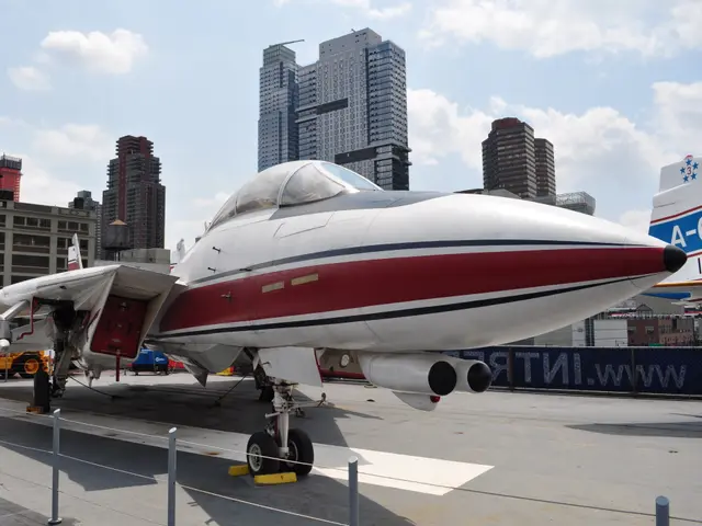 Grey Grumman F-14 Tomcat with wings swept forward on the flight deck of Intrepid