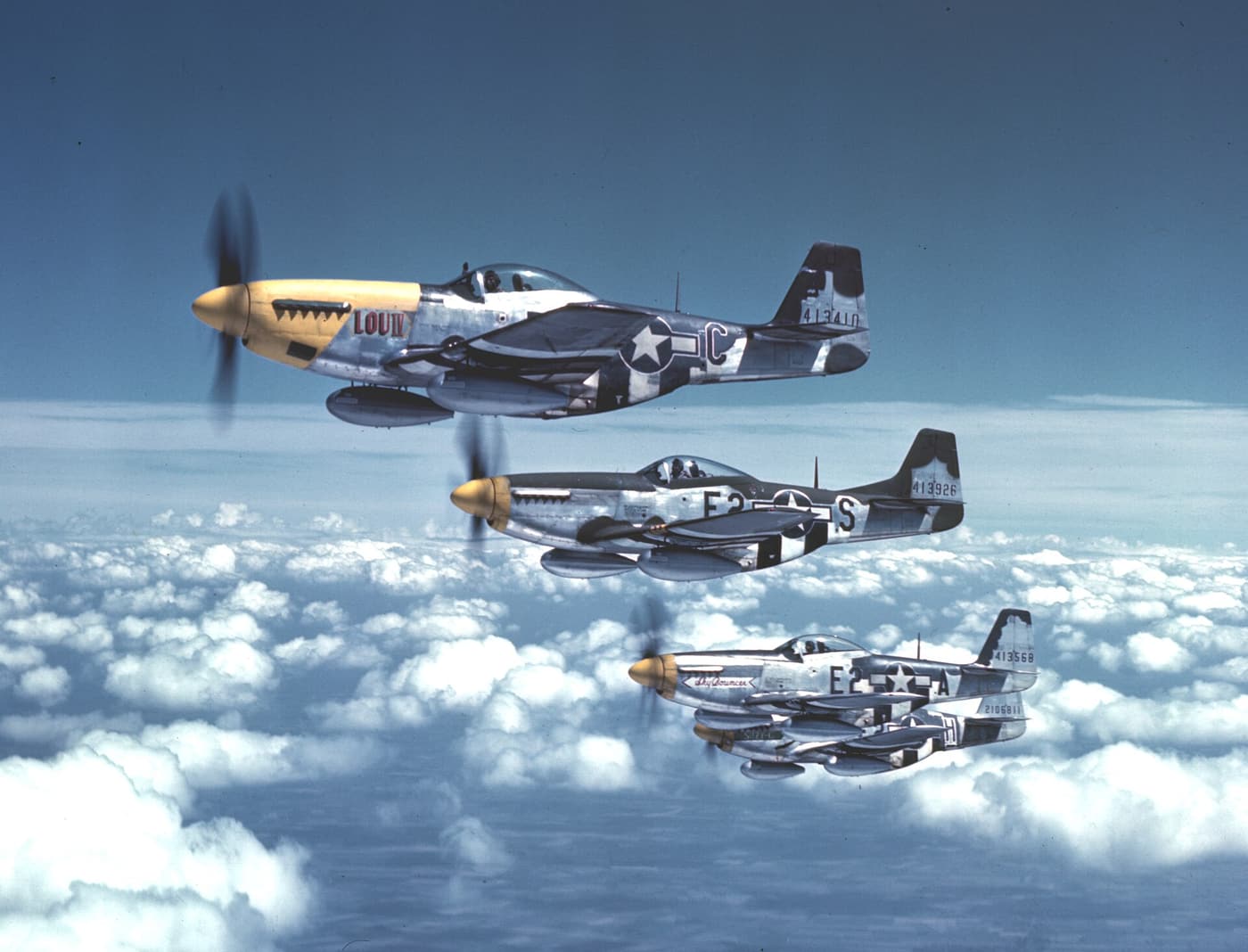 Four P-51 Mustangs of the 361st Fighter Group in echelon formation